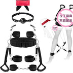 Black padded restraint system with thigh, wrist and ankle cuffs connected to a wide waist belt