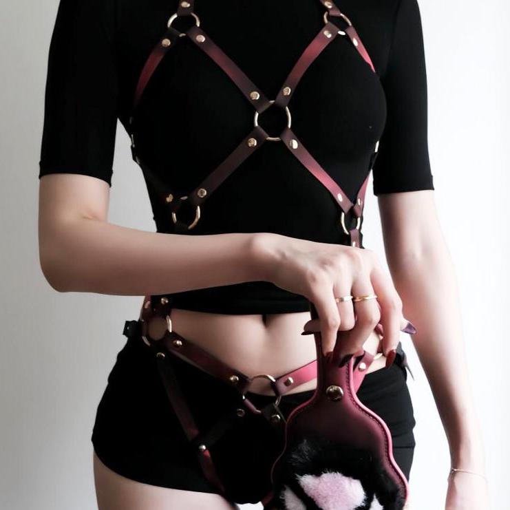 Dark red ring-detail full-body harness on mannequin