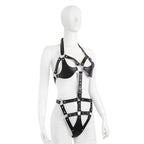 Side view of black harness bodysuit with connecting straps and hip panel