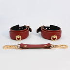 Burgundy red adjustable leather cuffs with detachable connector strap