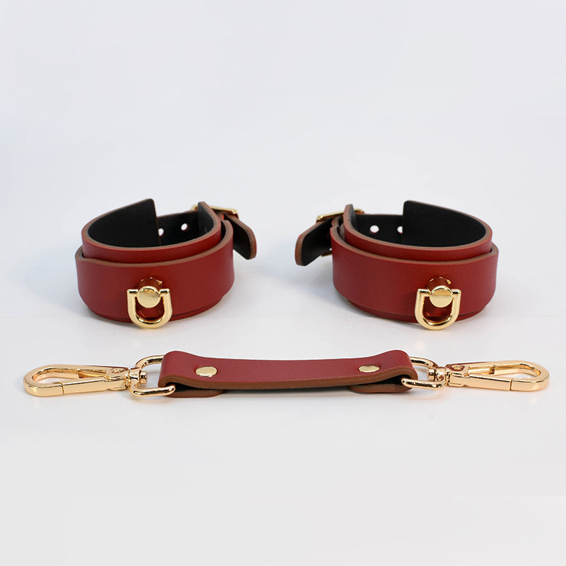 Burgundy red adjustable leather cuffs with detachable connector strap