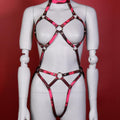 Red and black full-body harness with ring details on mannequin