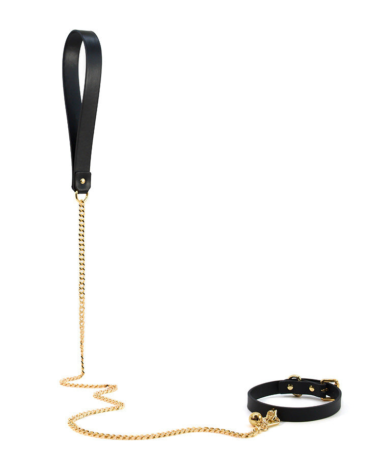 Black leather wrist cuff with handle and gold-tone chain lead