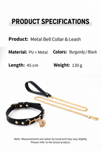 Burgundy collar with gold-tone bell charm and chain leash on display