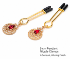 Gold-tone nipple clamps with red gemstone and pearl pendants